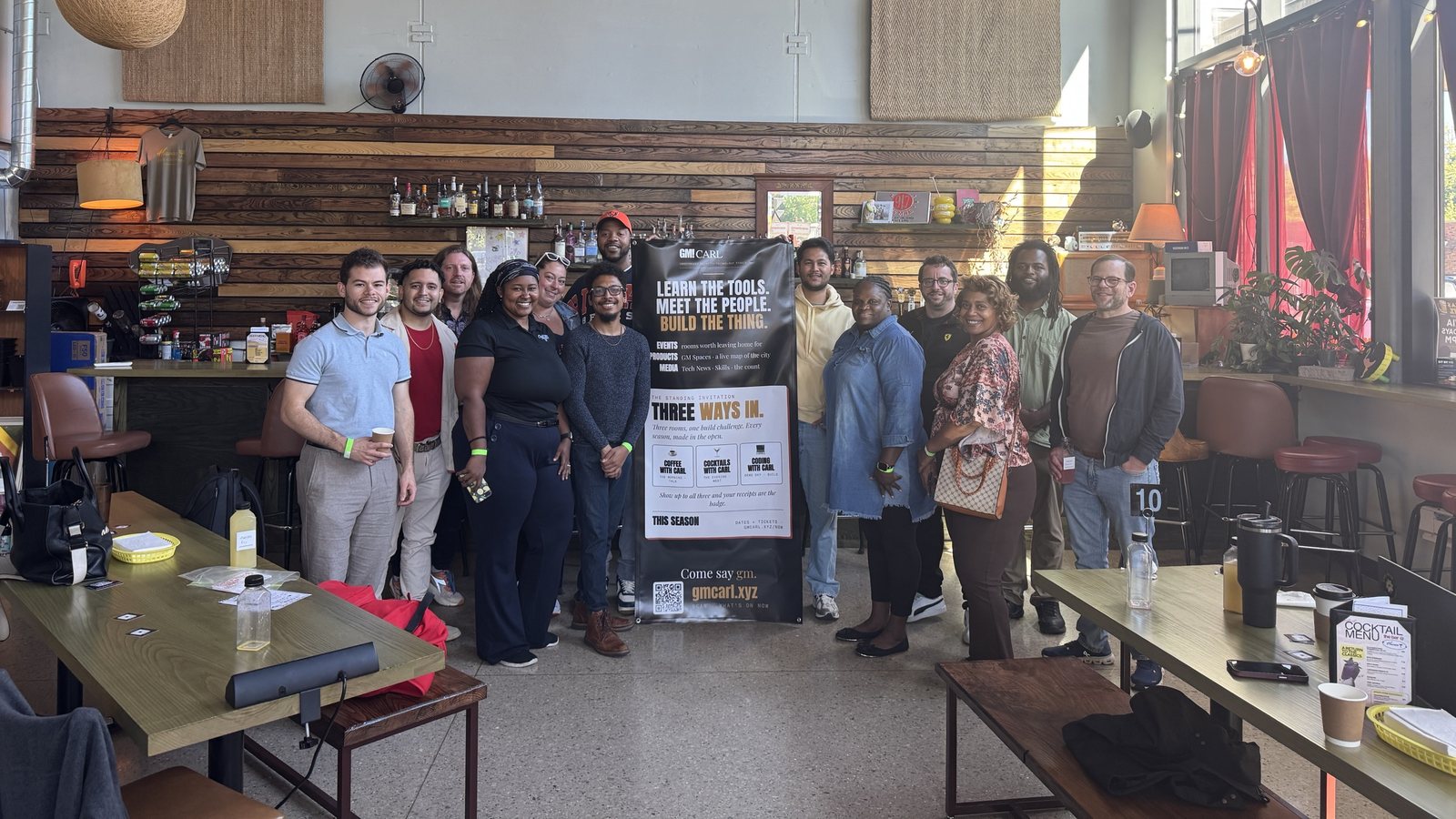 The Coffee with Carl room at Haven Cafe, September 26, 2026, seventeen people around the Season 0 banner